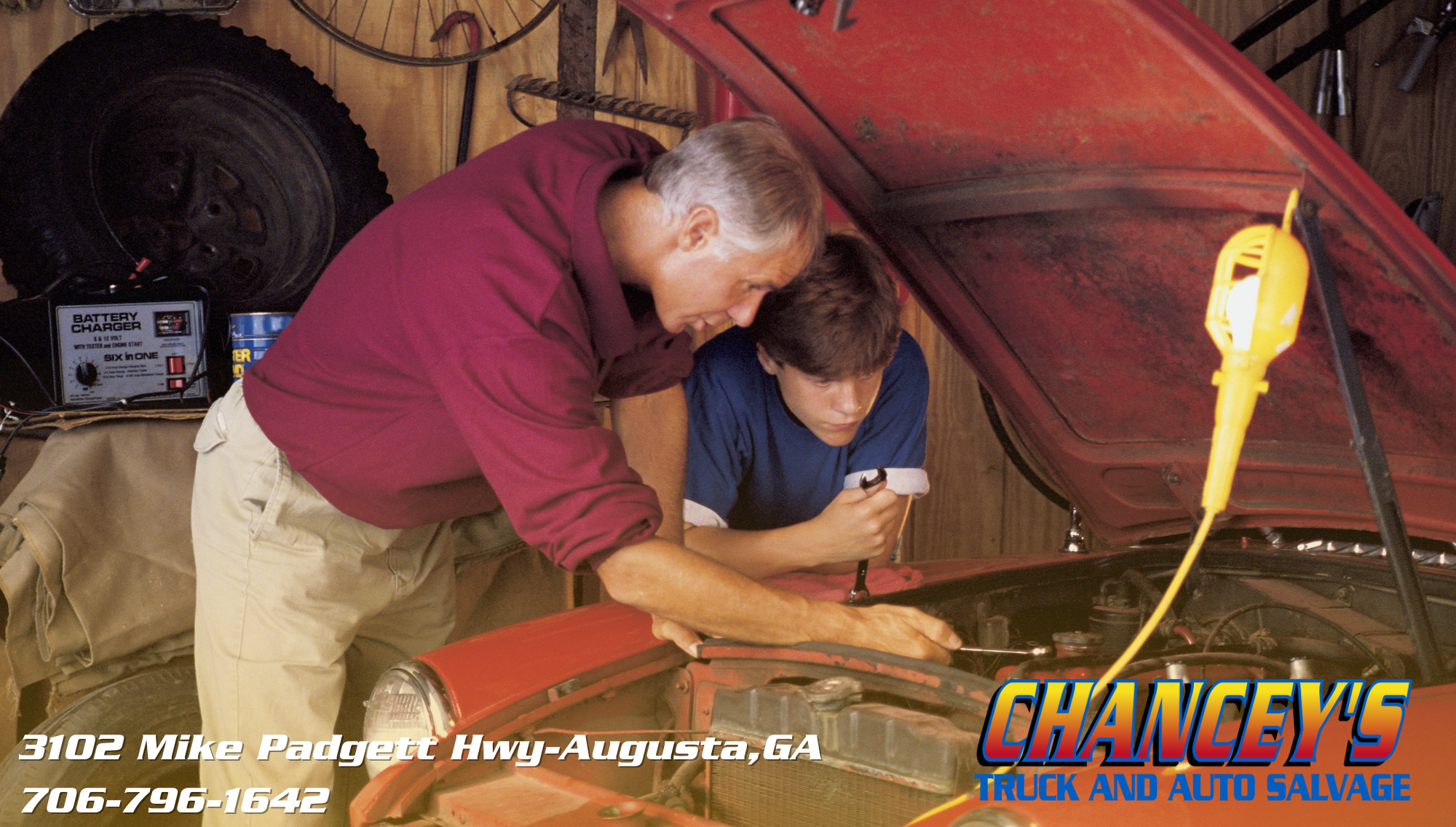 a father and son work together restoring an old vehicle